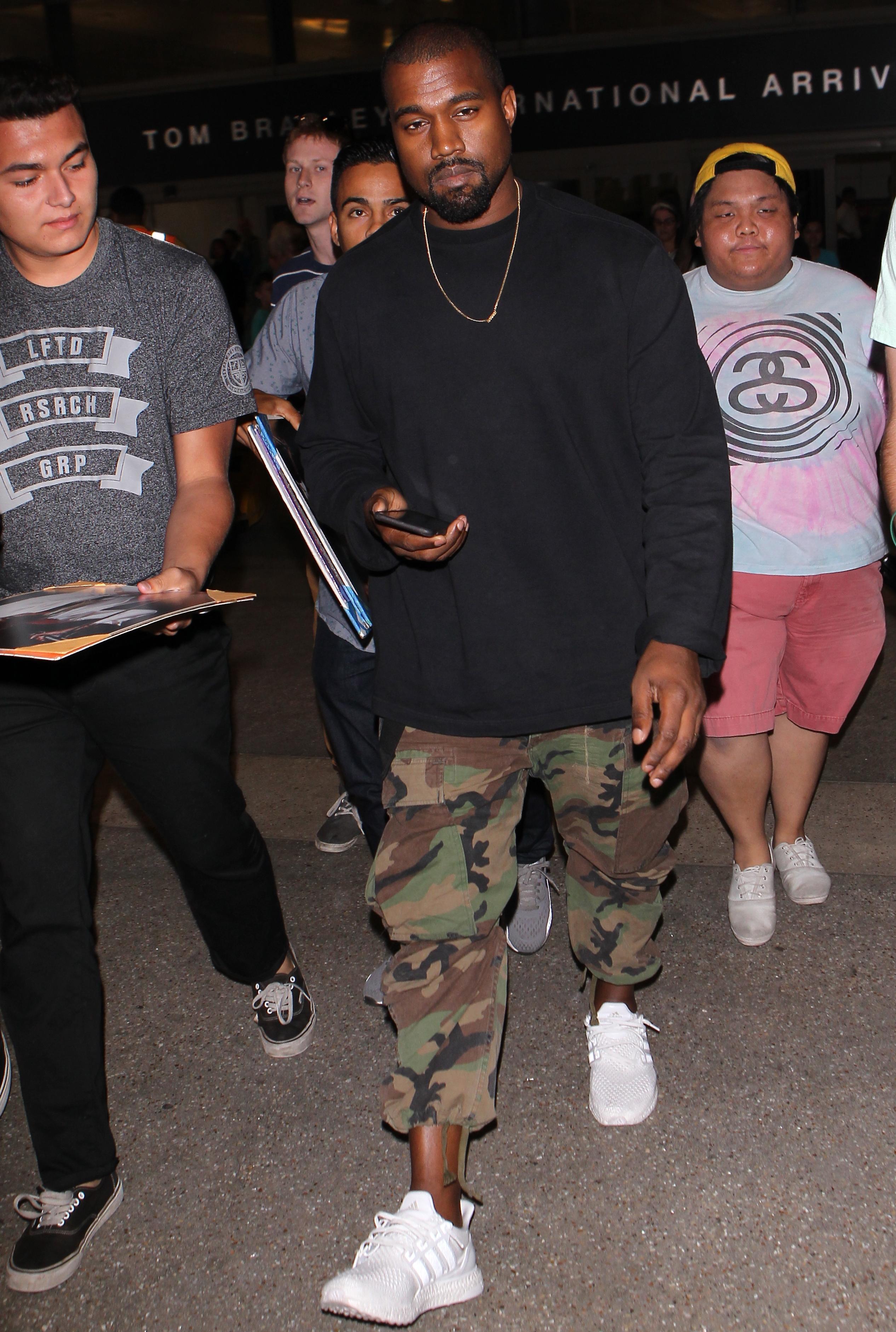 Kanye West spotted  at LAX returning to Los Angeles