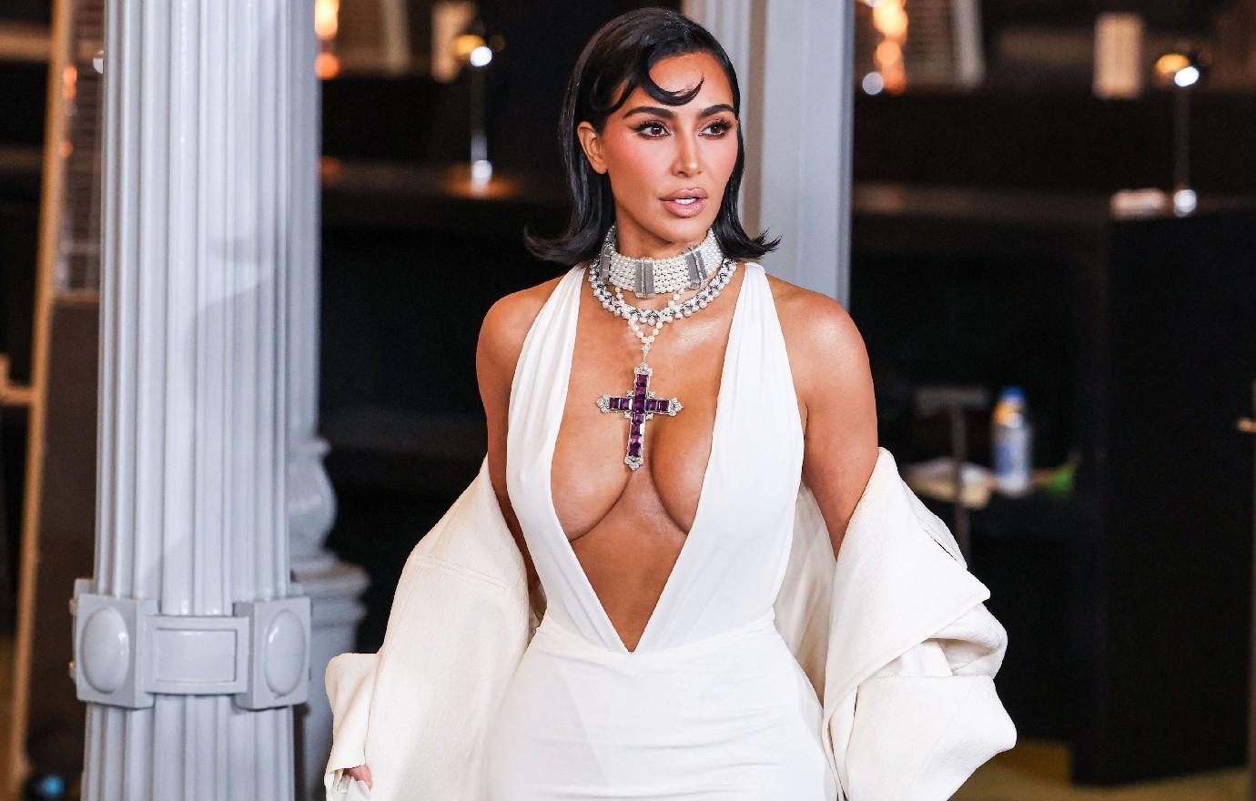 kim kardashian wearing princess diana cross necklace vulgar cleavage