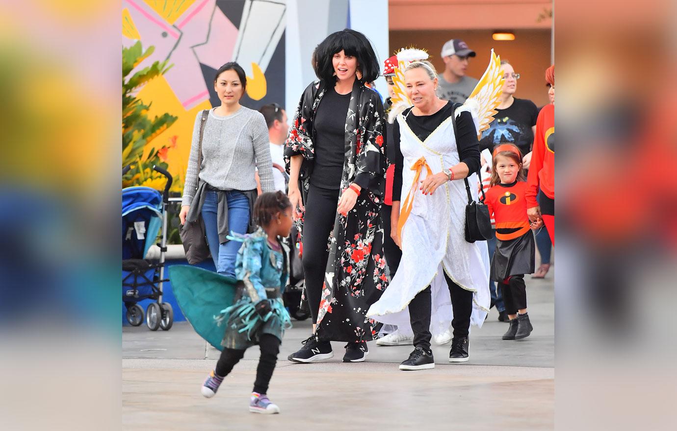 EXCLUSIVE: Charlize Theron dresses up as Edna from the Incredibles movie while out at Disneyland with her family