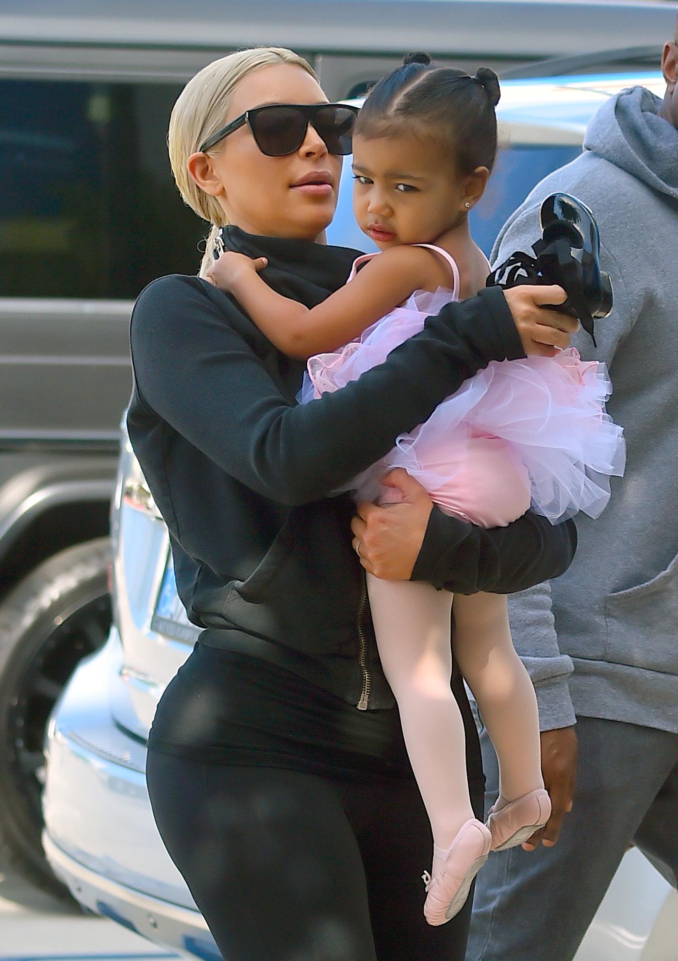 Kim Kardashian and Kourtney Kardashian take their daughters to a dance class in woodland hills