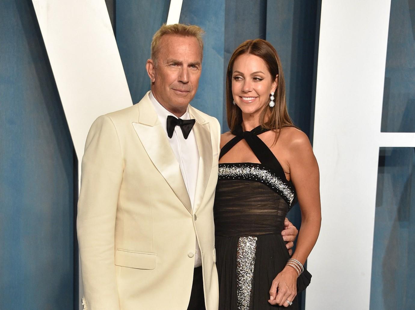 Kevin Costner's estranged wife wears Prada purse after begging