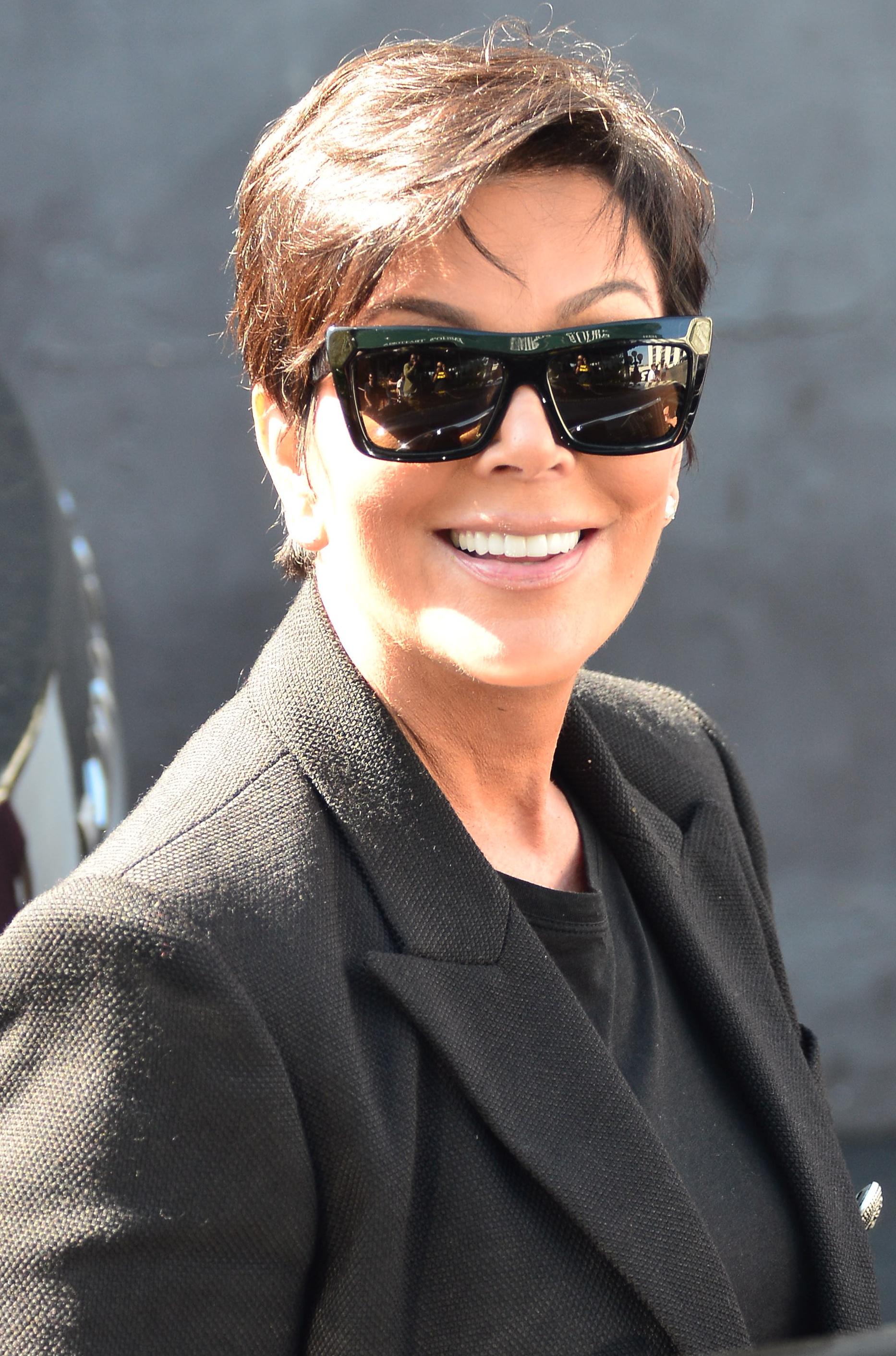 Kardashian family matriarch, Kris Jenner, is all smiles as she leaves Emilio’s Restaurant with Scott DIsick and stops to talk to daughter Kourtney who came to pick him up in Encino, CA