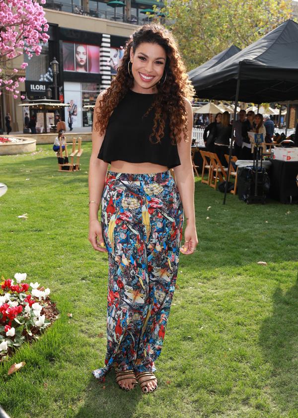 Singer Jordin Sparks shows off her toned abs in a crop top, and is all smiles, waving to the cameras while spotted shopping