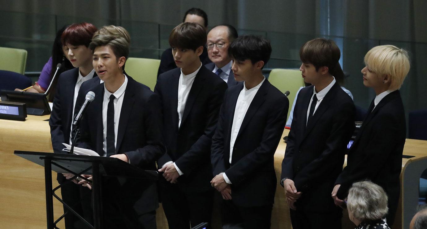 Korean K-Pop group BTS speaks as World Bank President Jim Yong Kim (C back in glasses) listens on the floor of the Trusteeship Council during the 73rd session of the General Assembly of the United Nations at United Nations Headquarters in New York, New York,