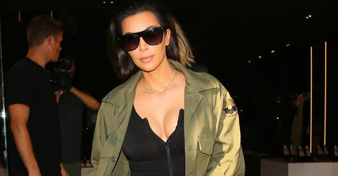 Kim Kardashian wears silver pants and a green jacket while shopping in Beverly Hills.