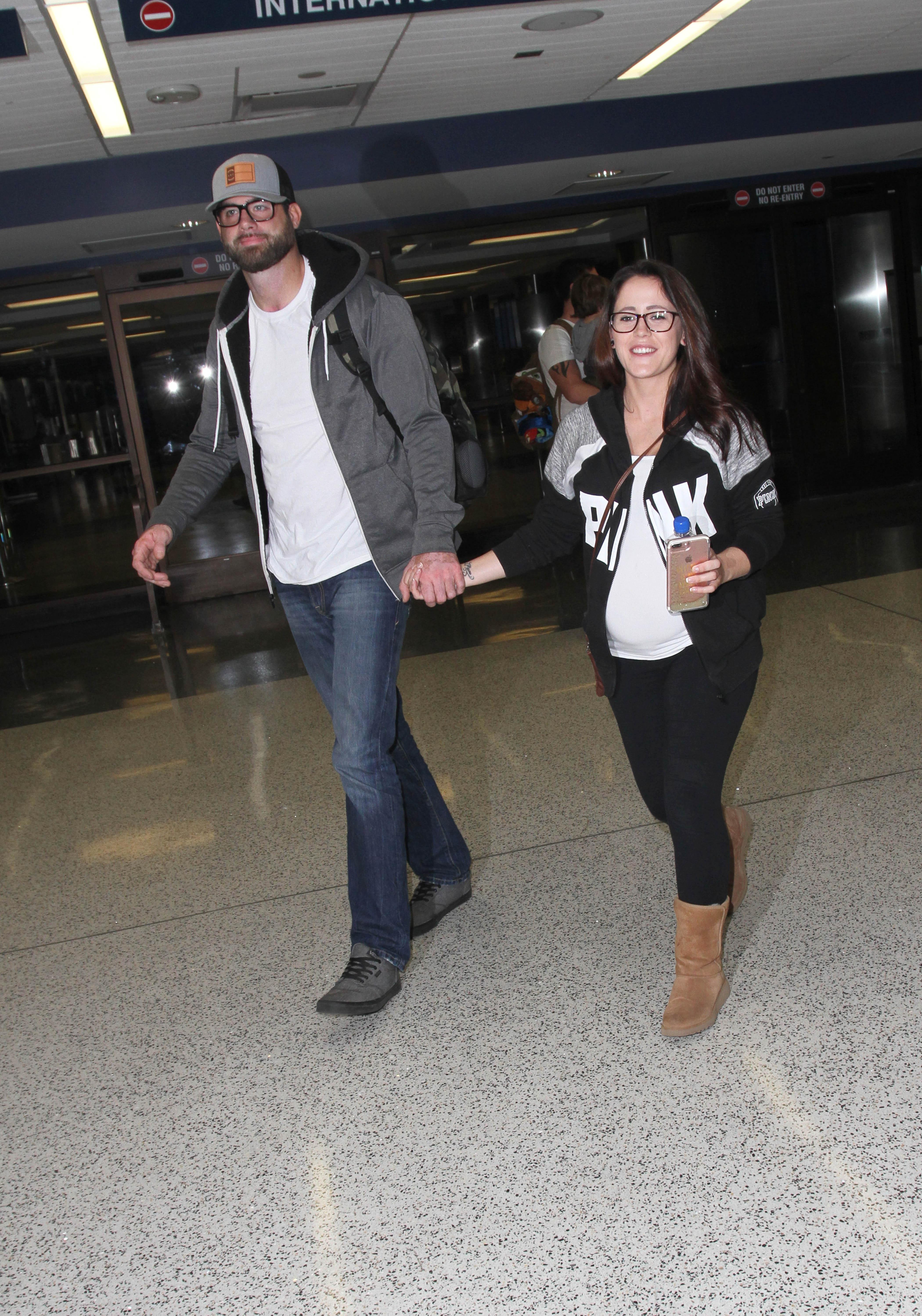 Pregnant Jenelle Evans is all smiles  as she arrives in LA with boyfriend boyfriend David Eason shortly after his court date is &#8220;postponed.&#8221;  The &#8220;Teen Mom&#8221; star was seen at LAX.