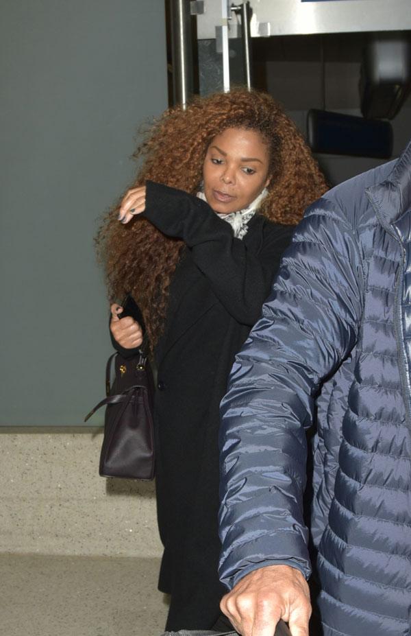 Janet jackson looks annoyed hiding neck scarf 03