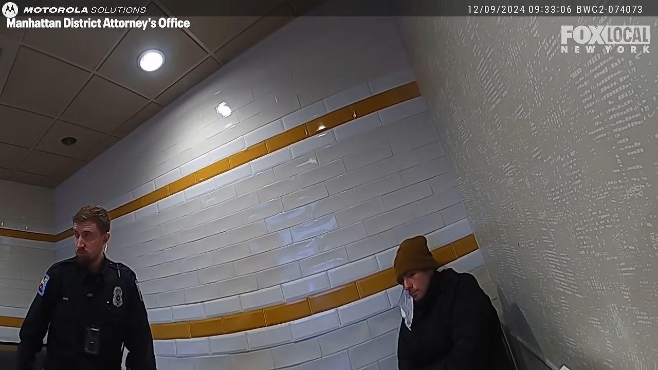 Image of Luigi Mangione and officer