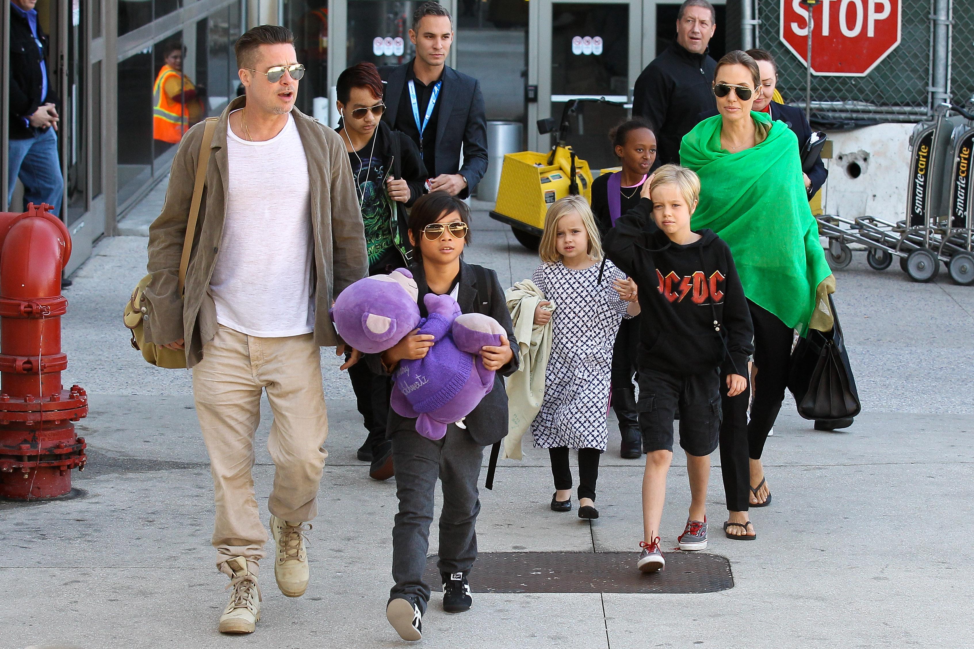 Brad Pitt, Angelina Jolie and family arriving at LAX