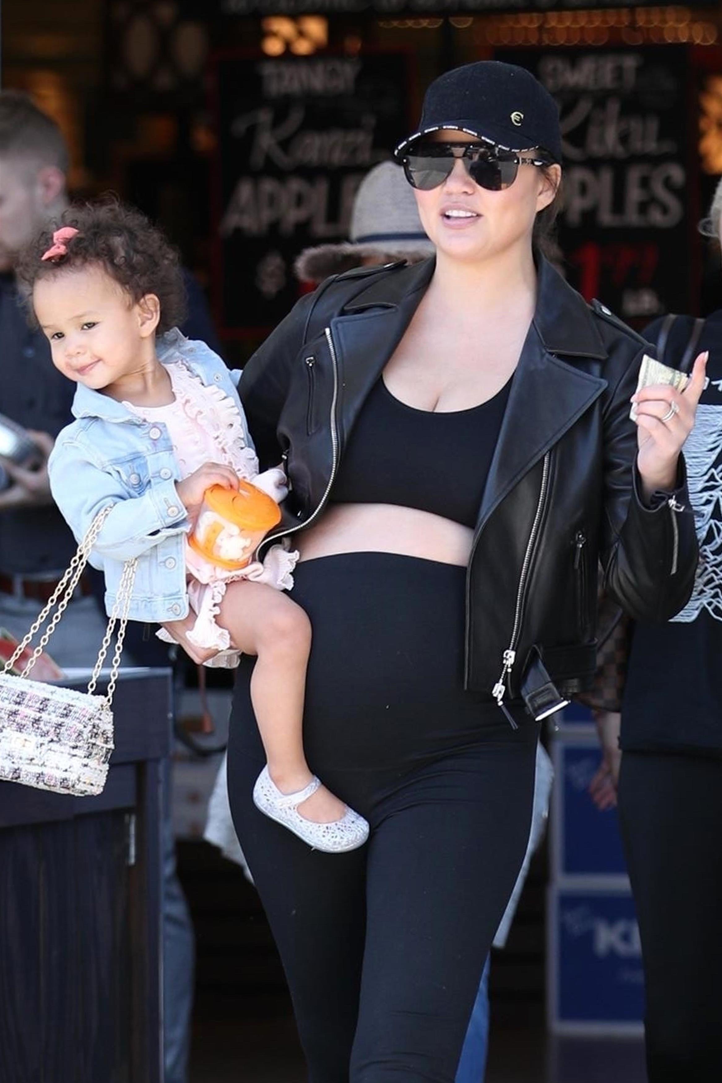 Chrissy Teigen Shows Off Her Baby Bump In Just A Sports Bra Leggings   BGUS 1211404 001 