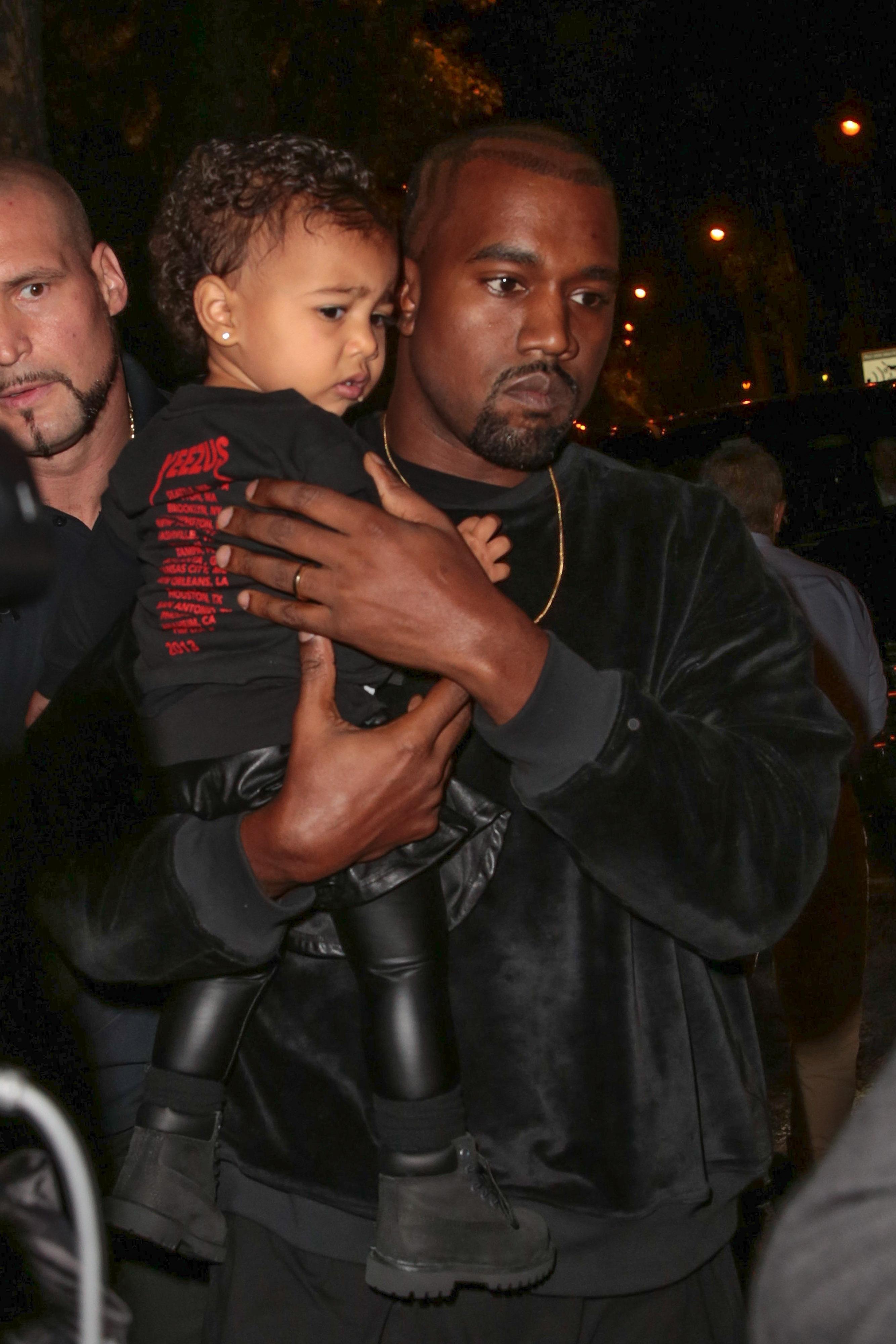 Kim Kardashian, Kanye West and their daughter at Paris Fashion Week Womenswear SS