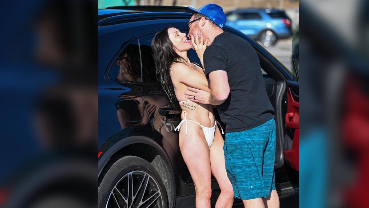 image of The couple kissed and laughed during their sunny outing.