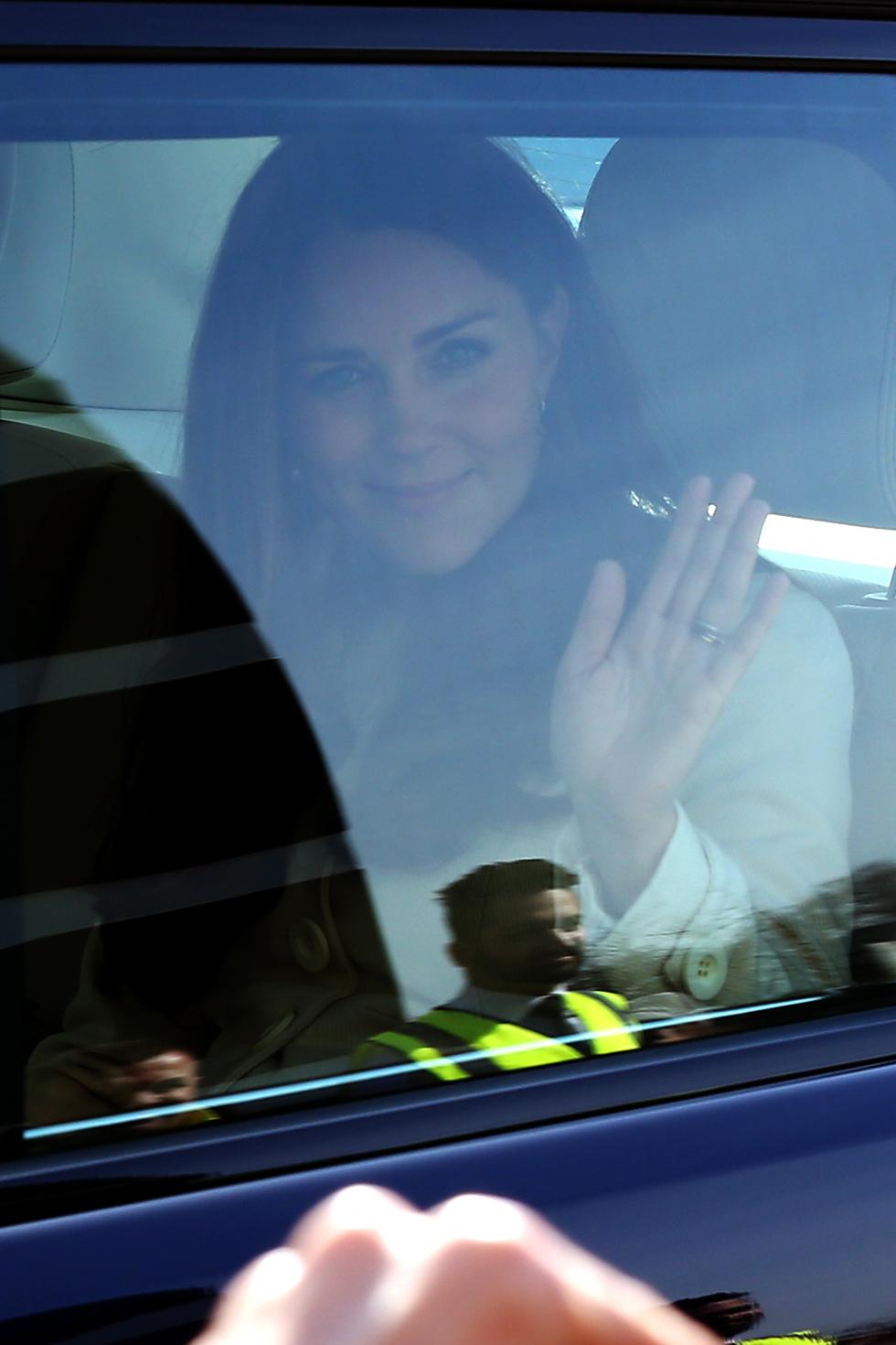 Catherine, Duchess Of Cambridge waves to onlookers as she departs the Ealing Studios in West London.