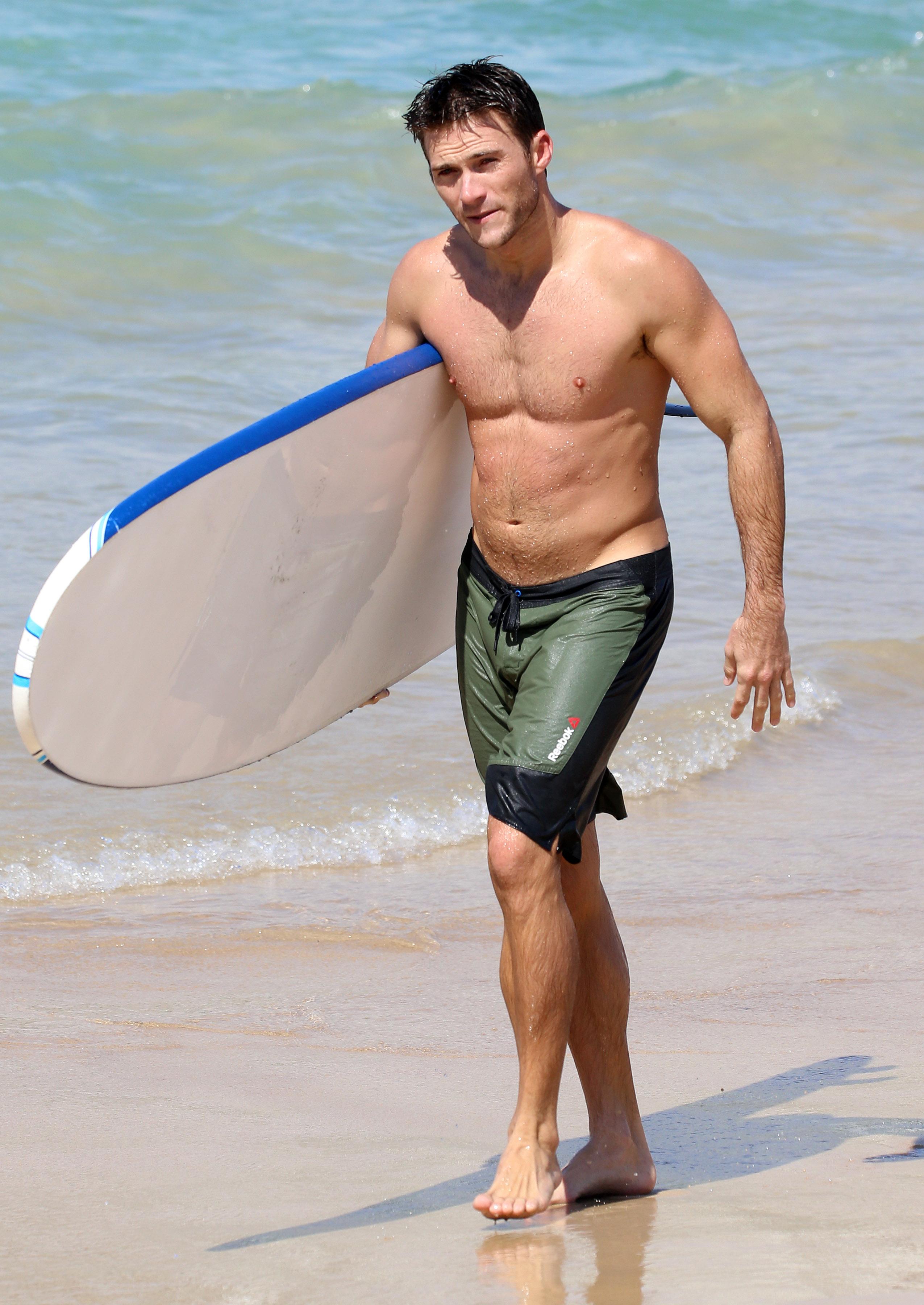 EXCLUSIVE: Scott Eastwood shows off his muscles while surfing at Bondi Beach.