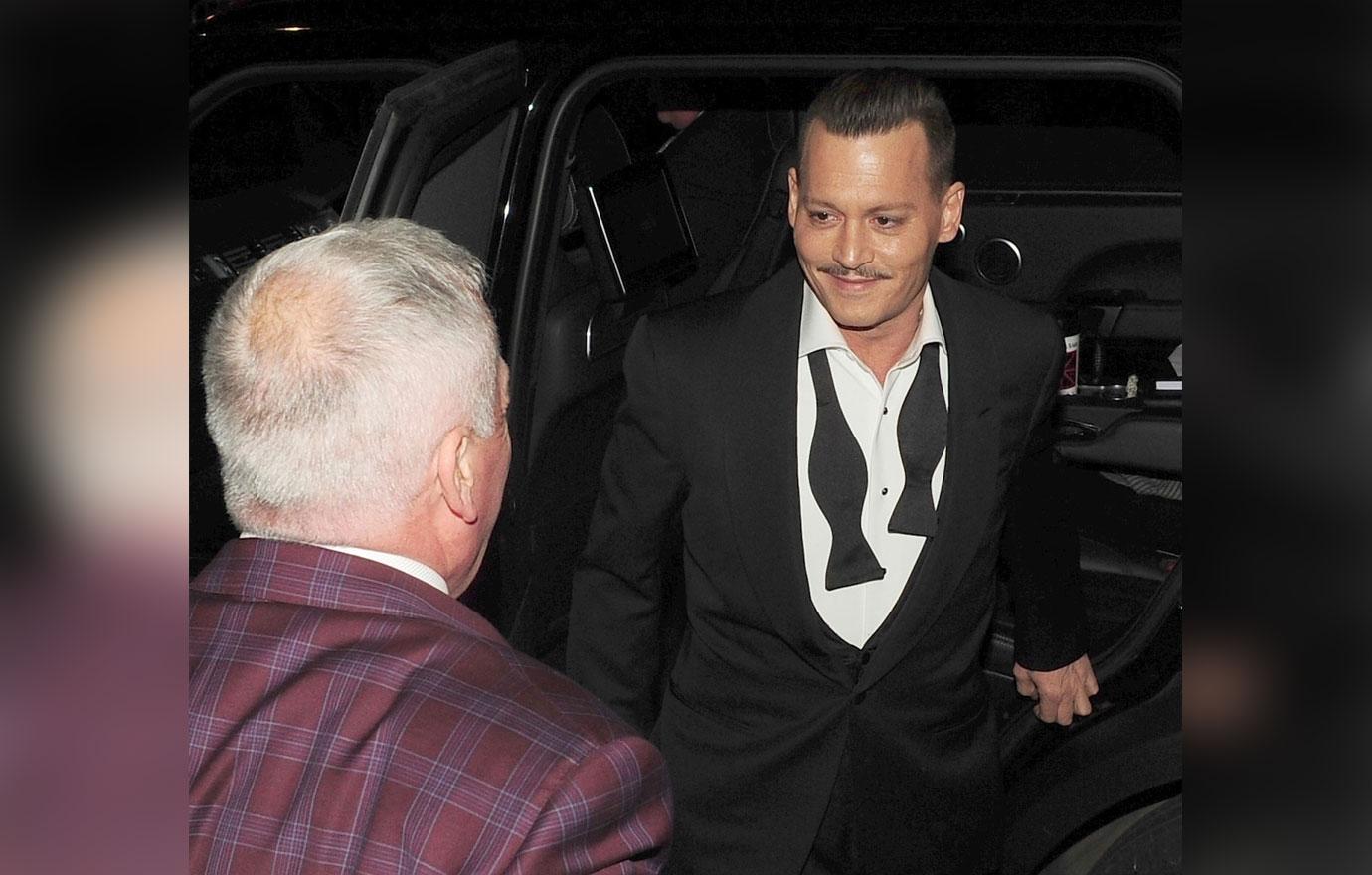 Johnny Depp jokes around with his bodyguard at the &#8216;Murder on the Orient Express&#8217; premiere