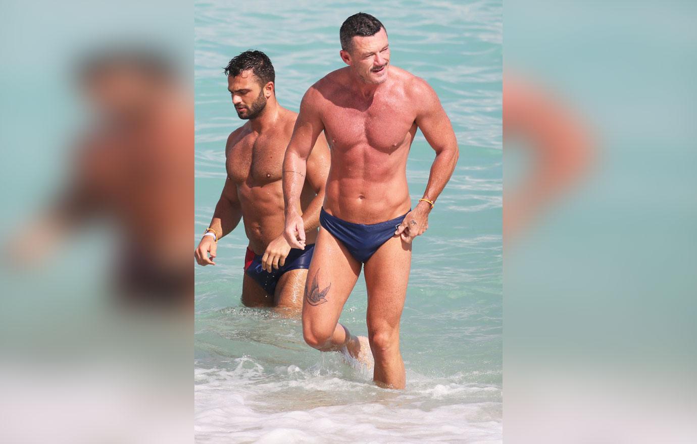 shirtless men on the beach luke evans