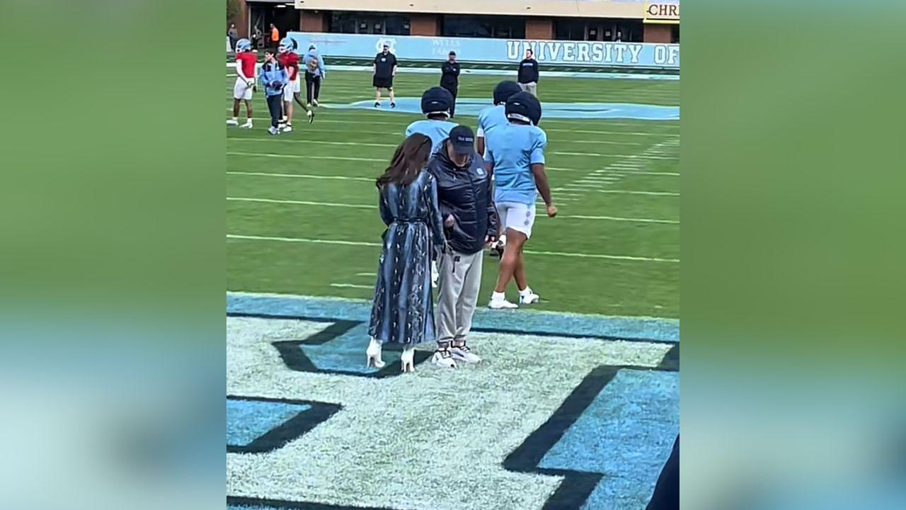 image of Jordon Hudson helps Bill Belichick with some personal scheduling outside UNC.
