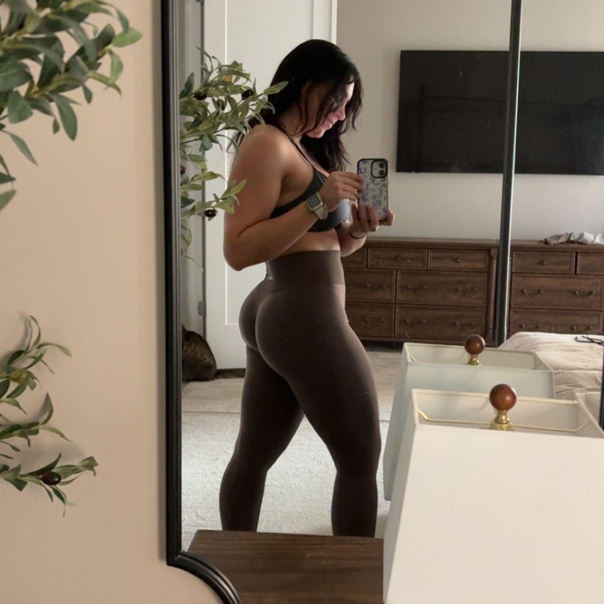 Mia Monroe takes a mirror selfie in her gym clothes.