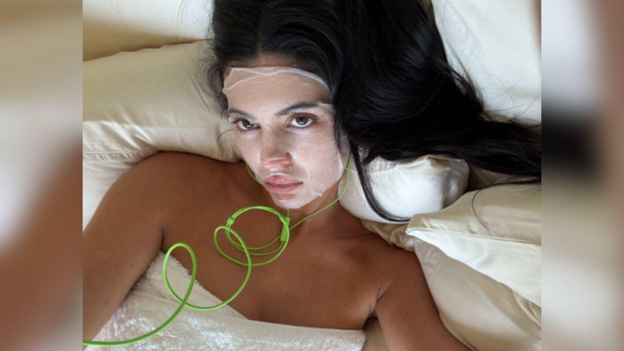 Image of Kylie Jenner stripped down to her towel for one of the photos. 