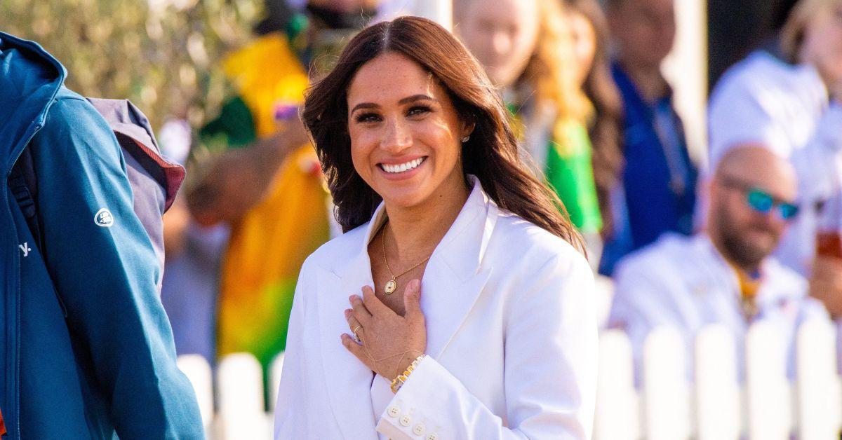 Photo of Meghan Markle turned heads in a white, long-sleeve minimalist gown.