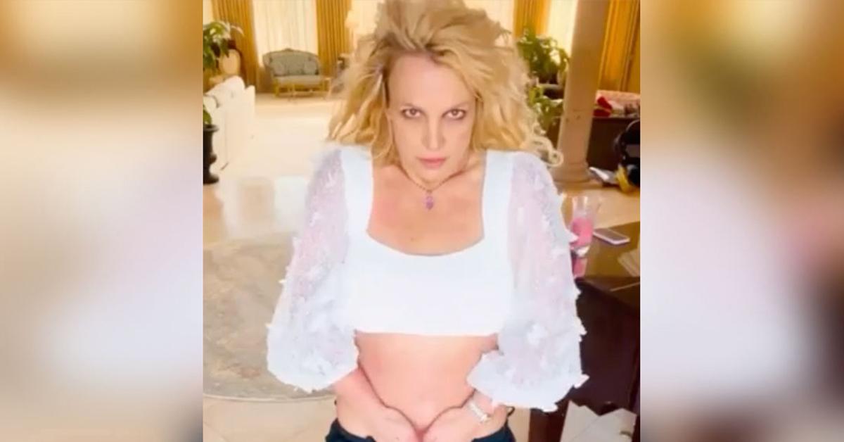 Britney Spears pushes her boobs together in tiny top and pulls her