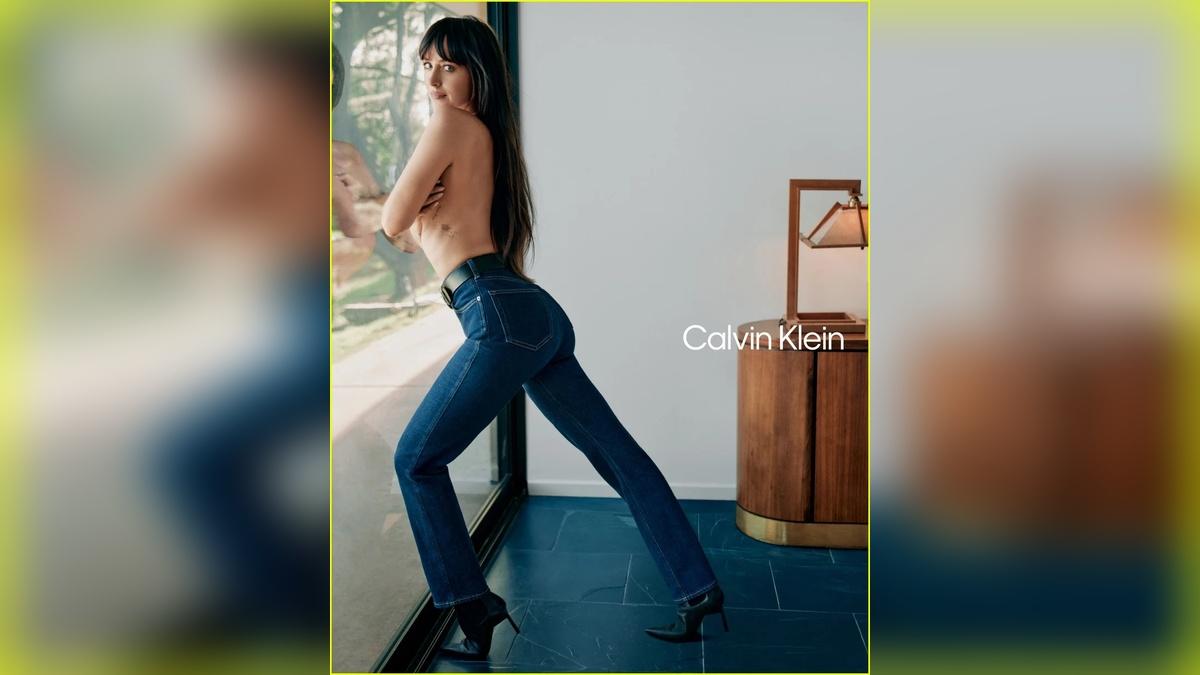 Image of Dakota Johnson caressed her bare body as she went topless.