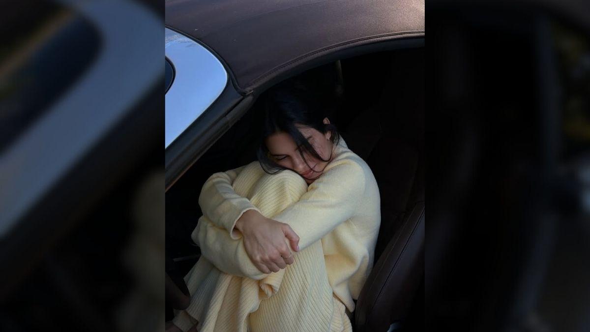 Image of She curled up in the front seat of a car in a candid, relaxed moment.