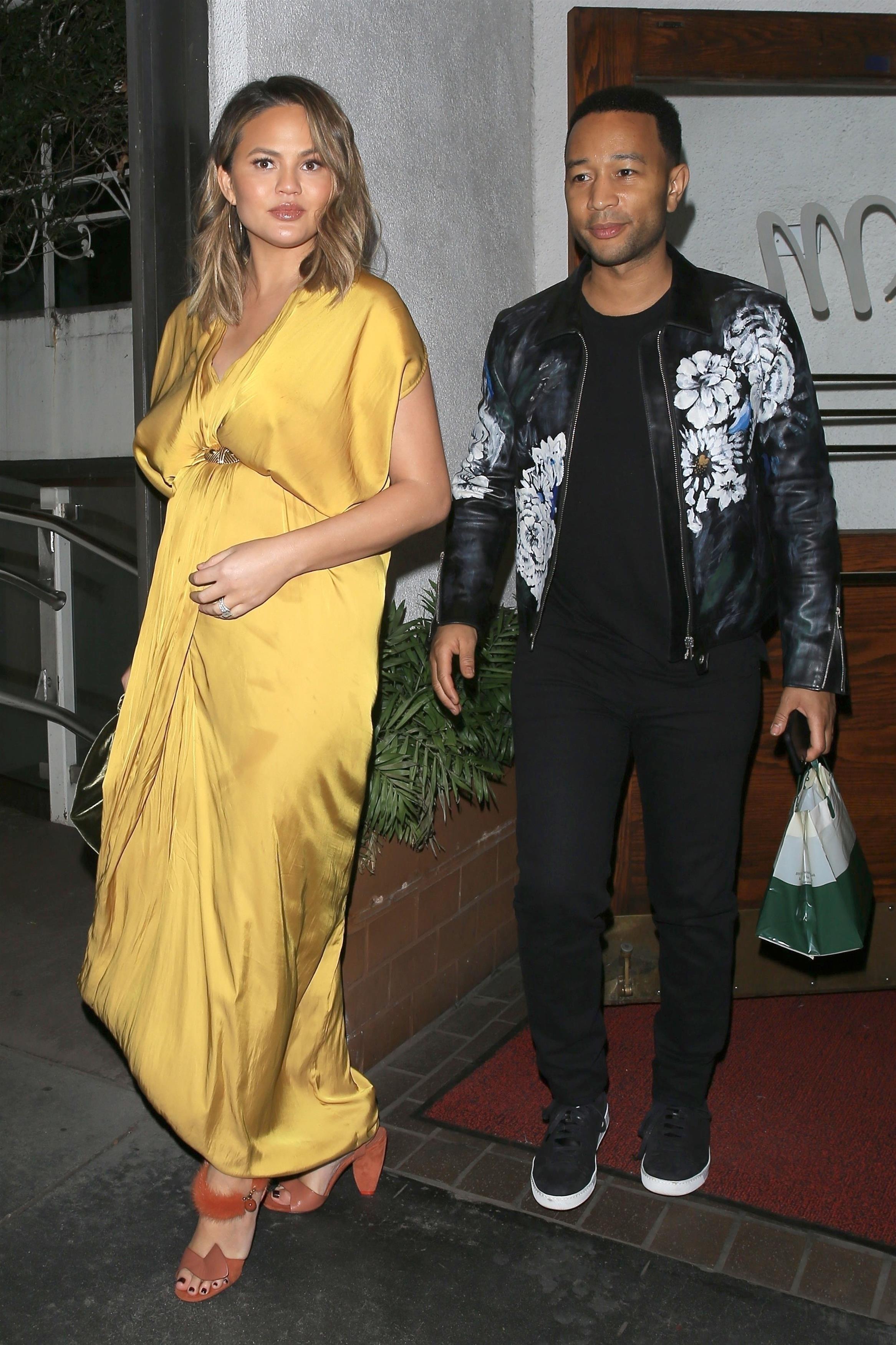 Pregnant Chrissy Teigen looks amazing in a gold dress for dinner with her man John Legend