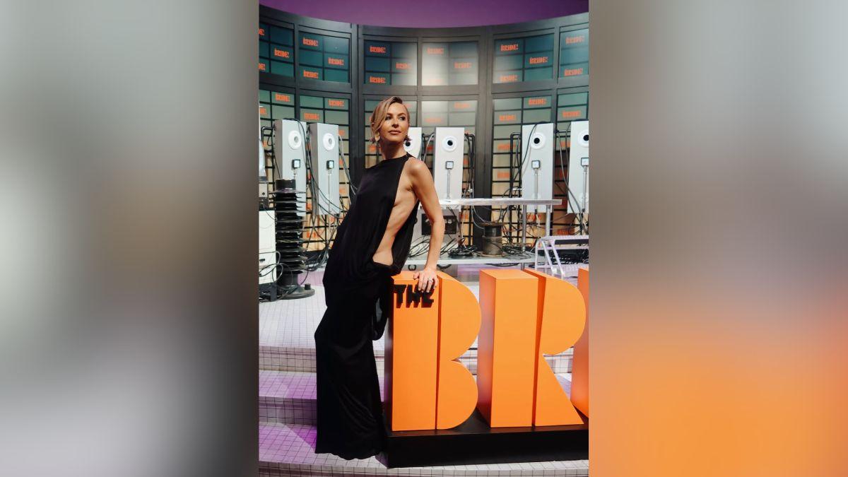 Image of Julianne Hough exposed side b--- in a black gown.