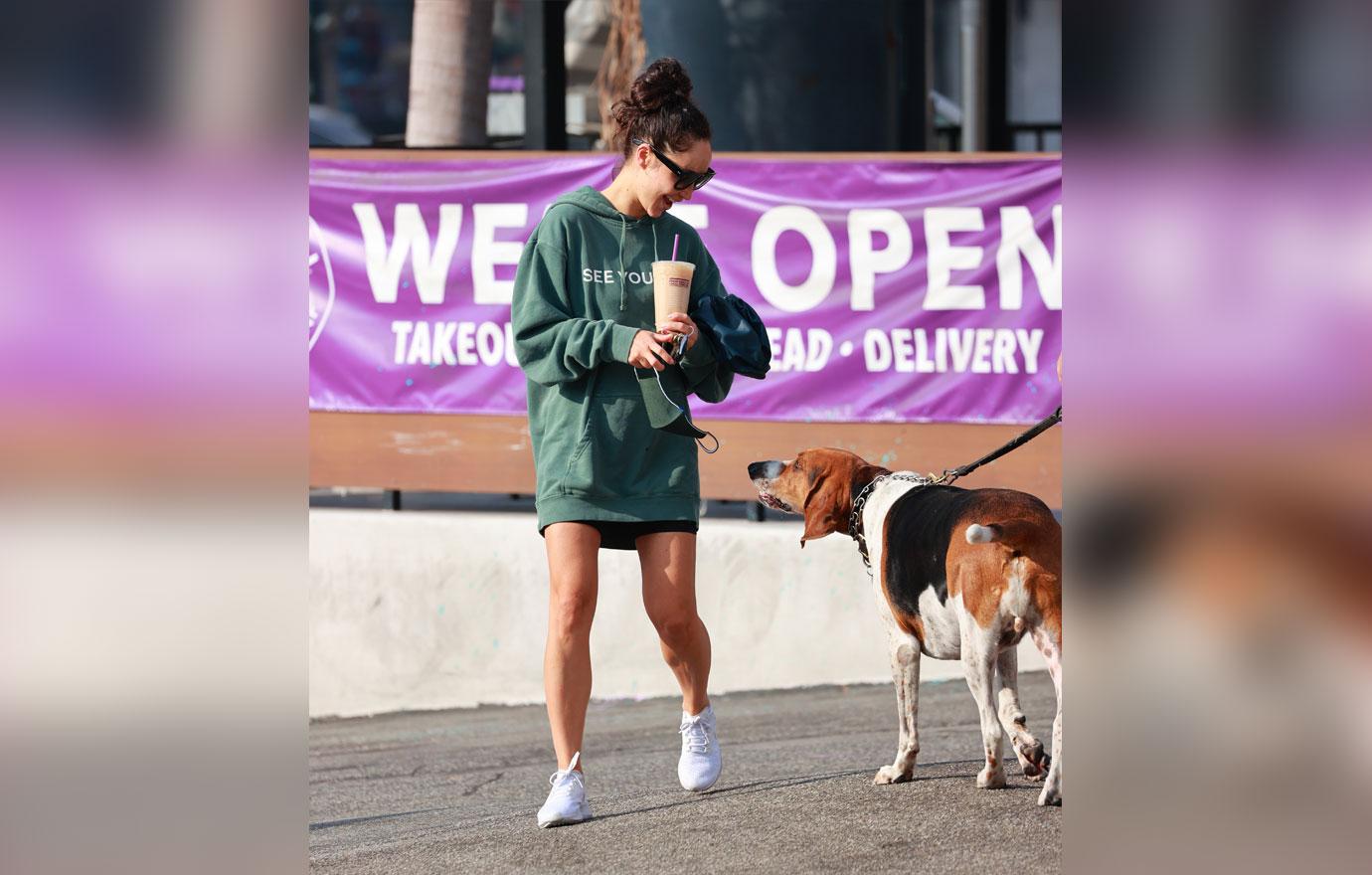 Cara Santana rocks a “see you in ‘21” Hoodie as she grabs an iced coffee after the gym. The top Made by Thirty Seconds of Mars