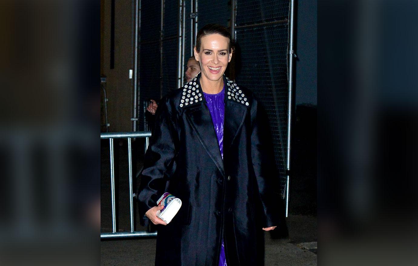 Sarah Paulson ties patent dress under overcoat and heels with socks together perfectly