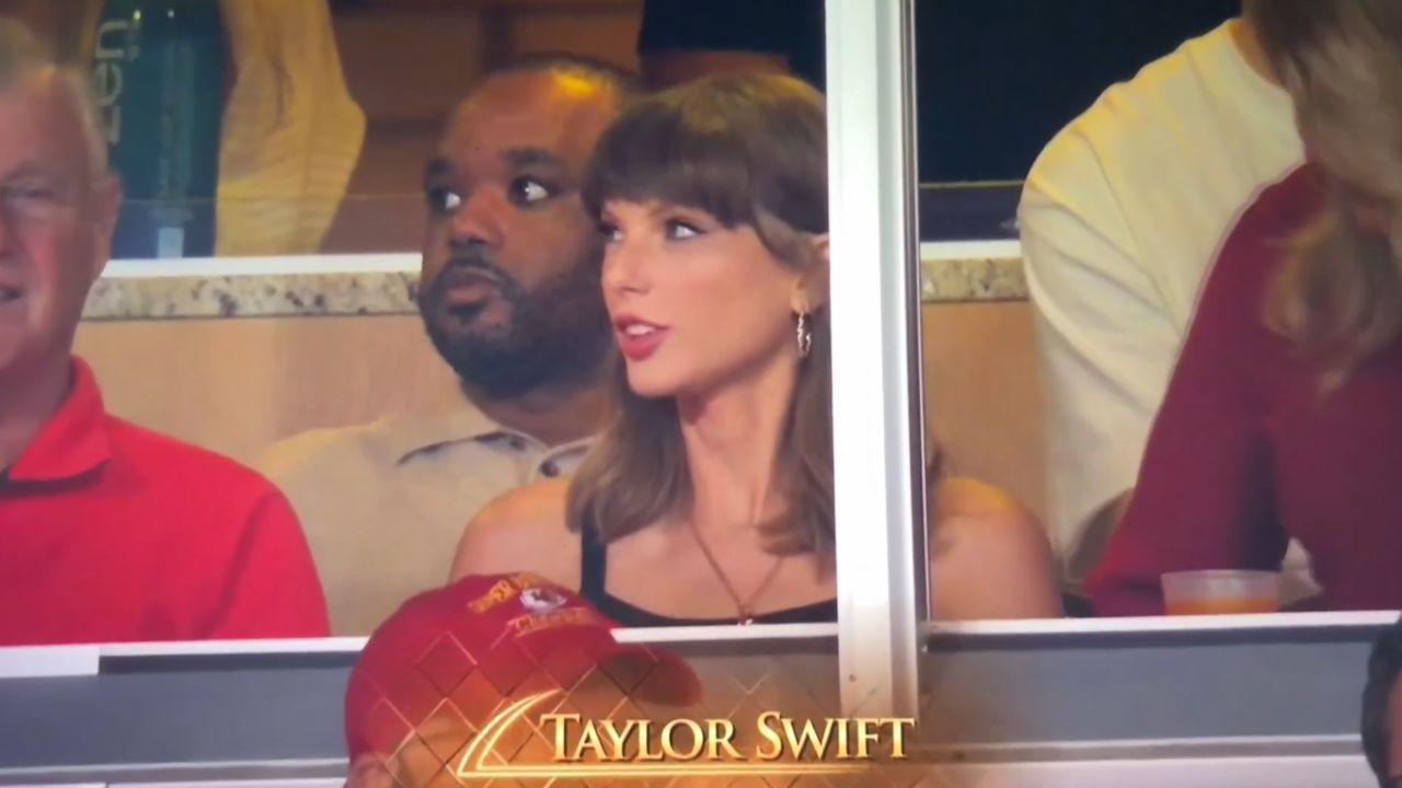 image of Taylor Swift pointed toward her wedding ring during the Chiefs' Week 2 game.