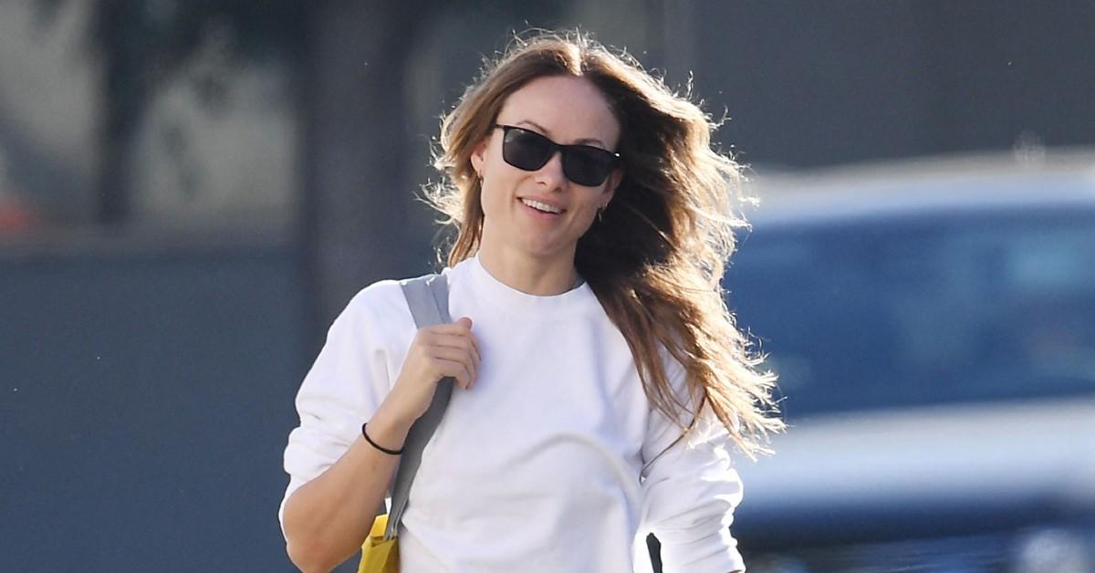 Olivia Wilde flaunts her rock hard abs in a crop top and purple leggings  while attending