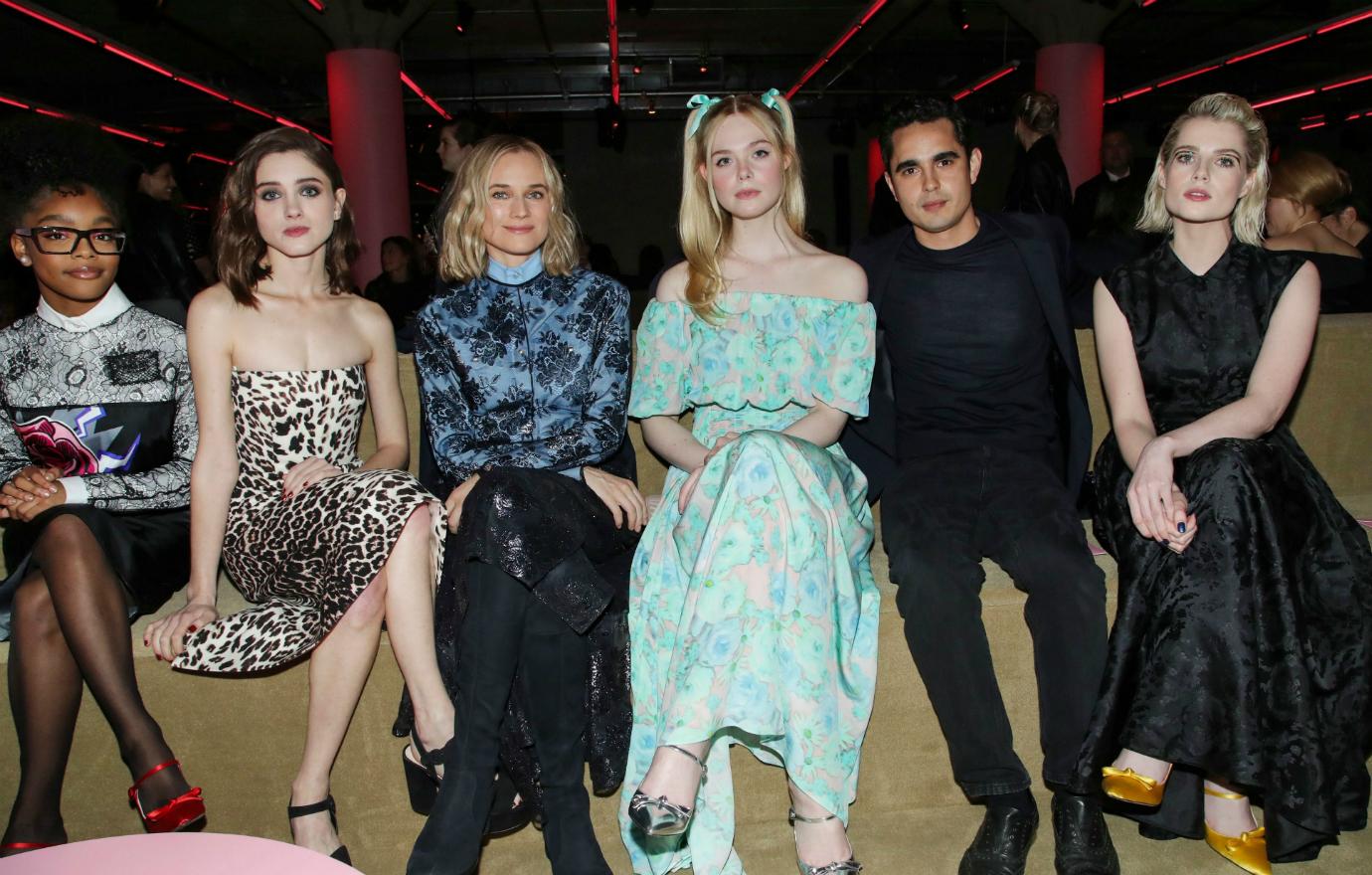 Lucy Boynton sits alongside her co-stars.