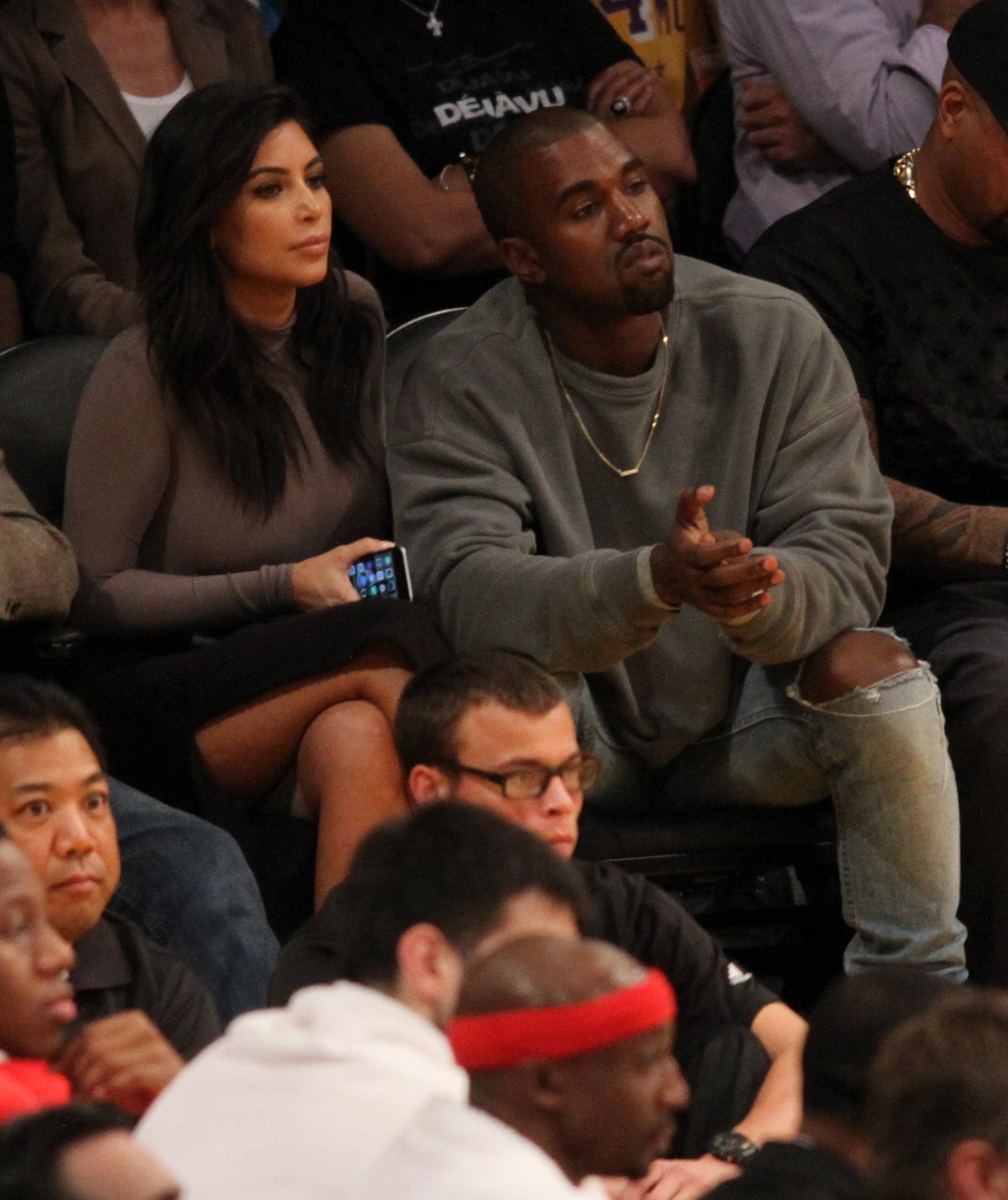 Kim Kardashian West and her husband Rappr Kanye West attend the Los Angeles Lakers season opener against the Houston Rockets at the Staples Center in Los Angeles, CA