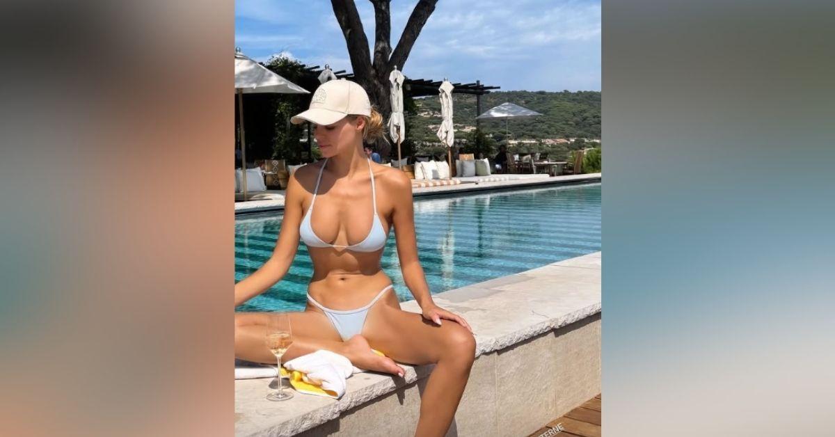 image of The 'DWTS' star posed in a tiny blue bikini by the pool.