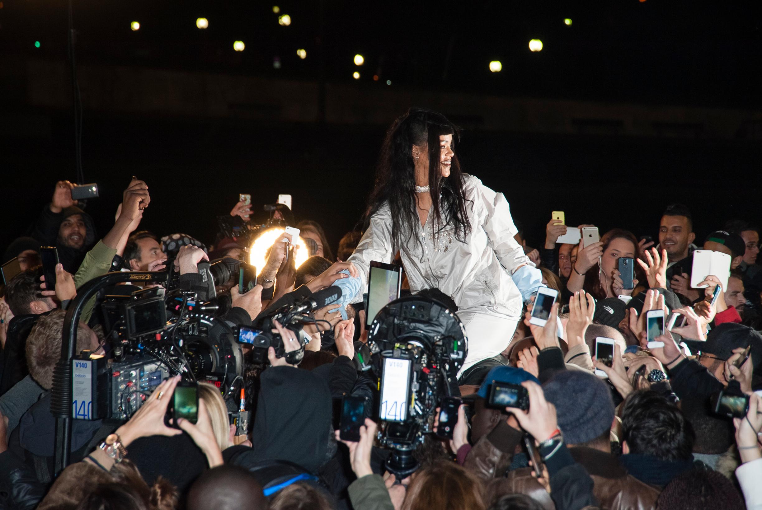 Rihanna surrounded by fans in Paris at Trocadero