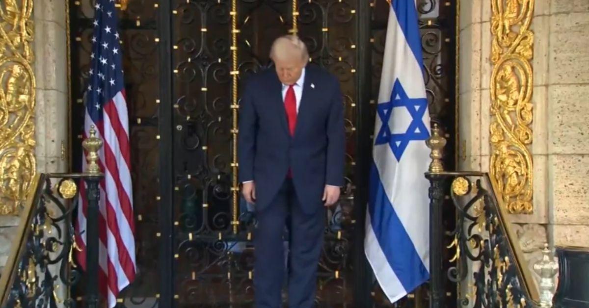 image of Donald Trump carefully walked down a short staircase.