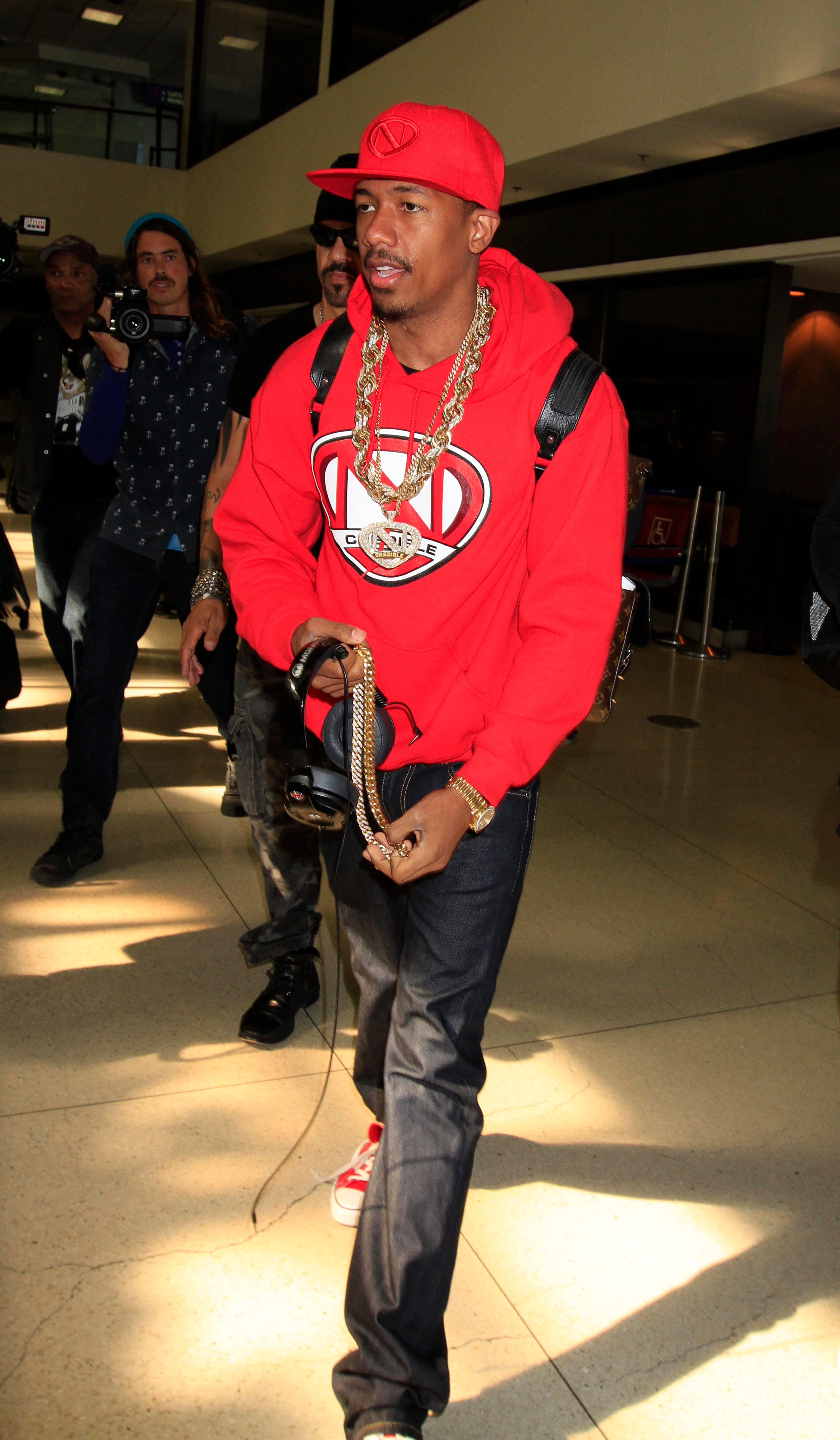 Nick Cannon is all smiles as he goes through TSA at LAX in Los Angeles