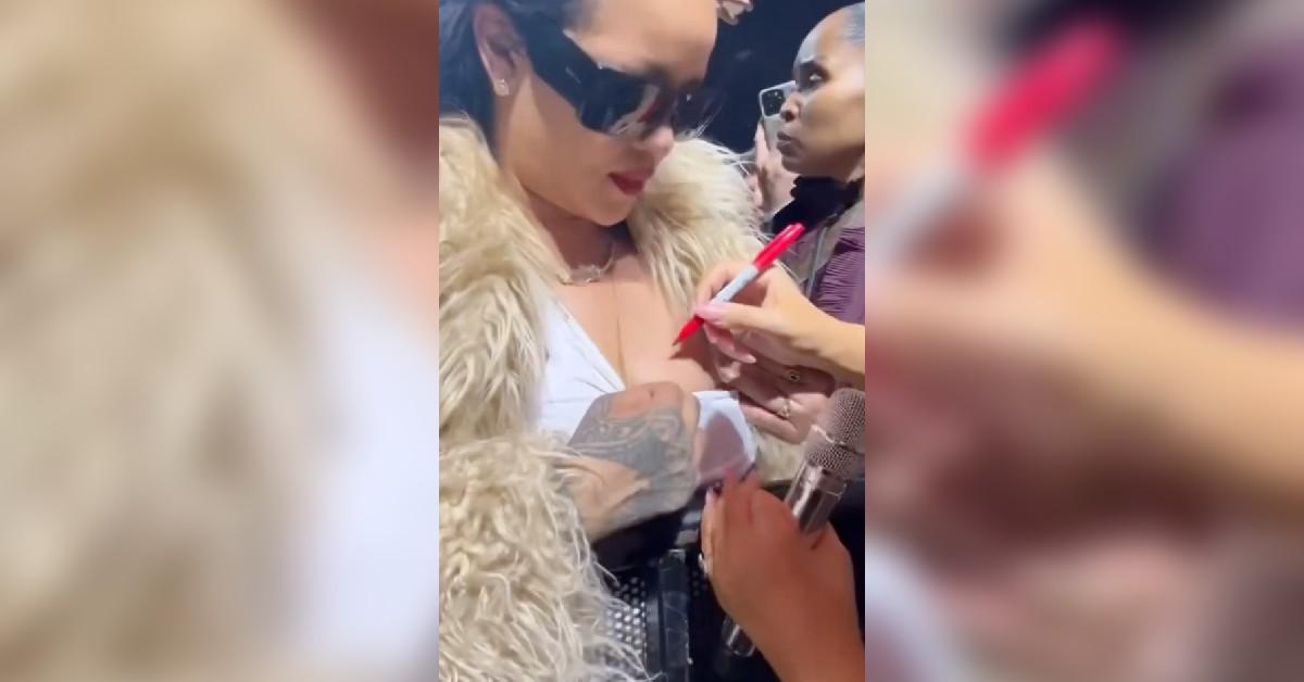 mariah carey signs rihanna chest christmas concert watch