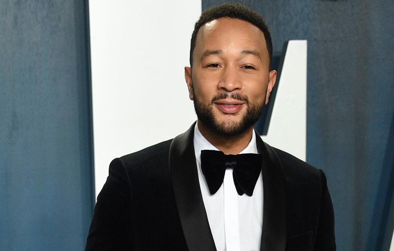 John Legend wore a traditional black tuxedo with a wide black bow tie and grey slacks.