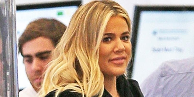 Khloe Kardashian hides her baby bump as she departs LAX