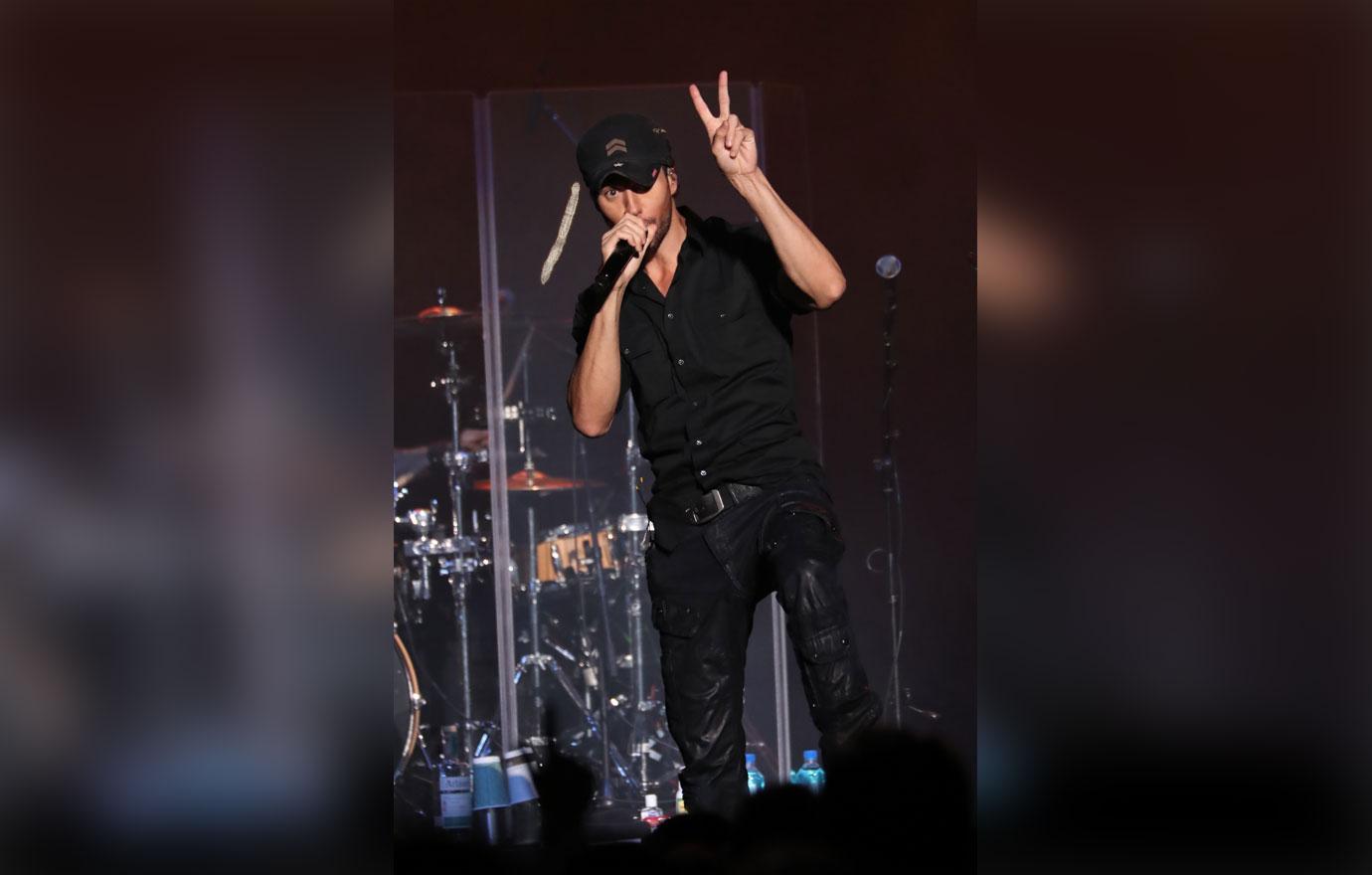 Enrique holding peace sign