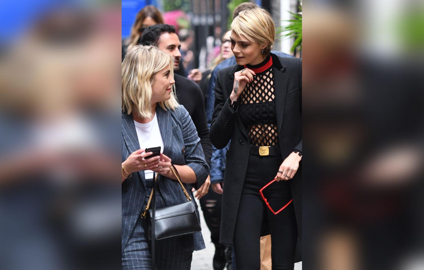 Ashley Benson and Cara Delevingne spotted laughing over a text message during TIFF