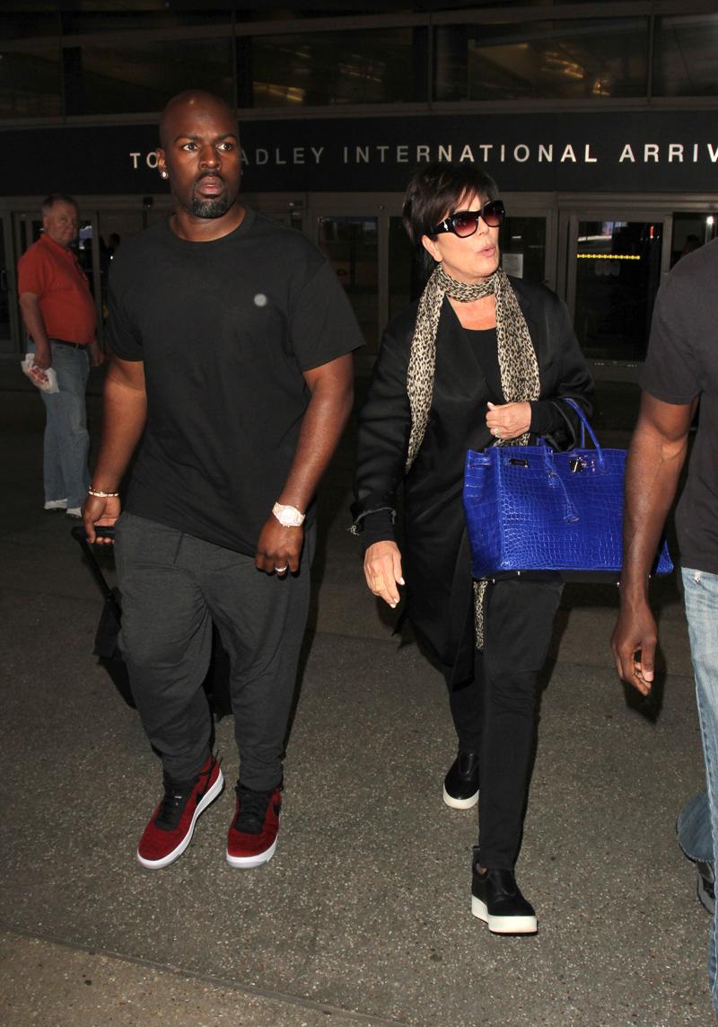 Kris Jenner and boyfriend, Corey Gamble are seen arriving into Los Angeles as they make their way to a waiting limo.  Both Jenner &amp; Gamble are wearing rings on their left hand as they are seen at LAX.