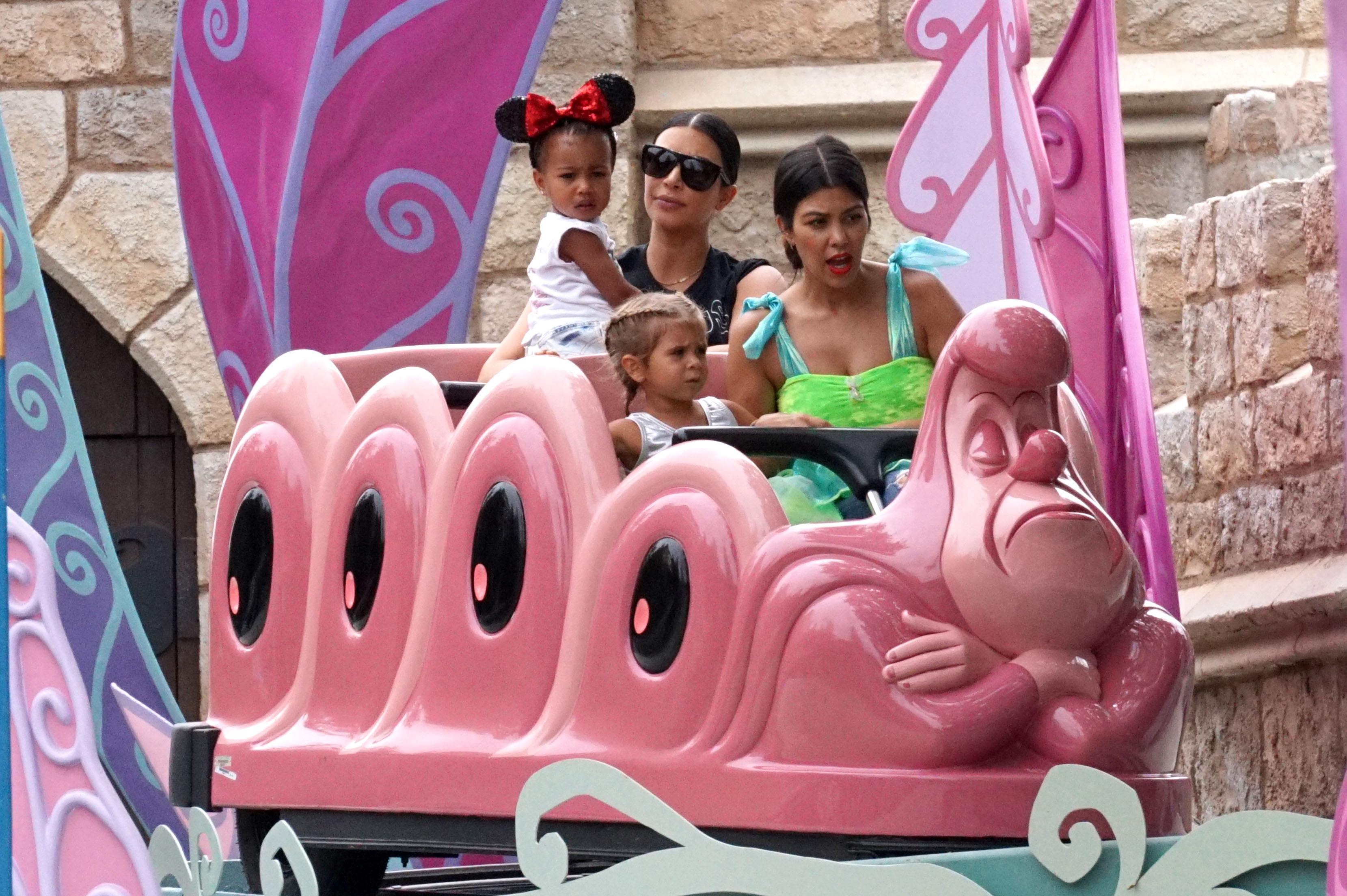 Kim Kardashian and Kourtney Kardashian ride the &#8216;Alice in Wonderland&#8217; ride at Disneyland!