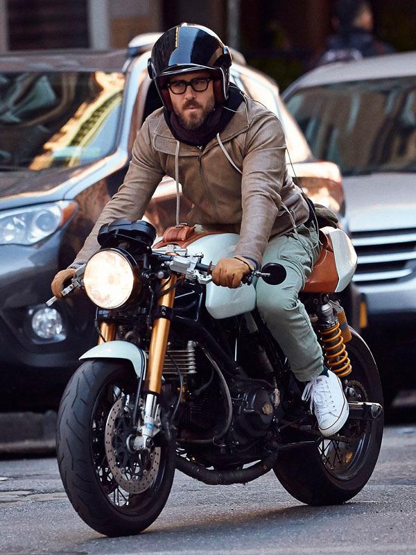 Ryan Reynolds riding on his motorcycle in the SoHo neighborhood of NYC