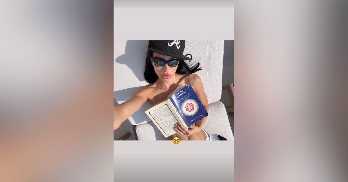 Image of Amelia Gray ditched her top while reading a book.