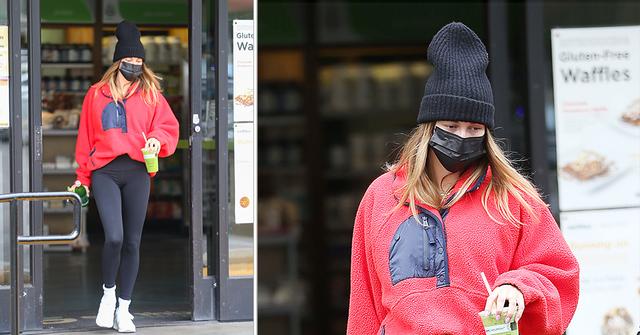hailey bieber picks up a green juice in la