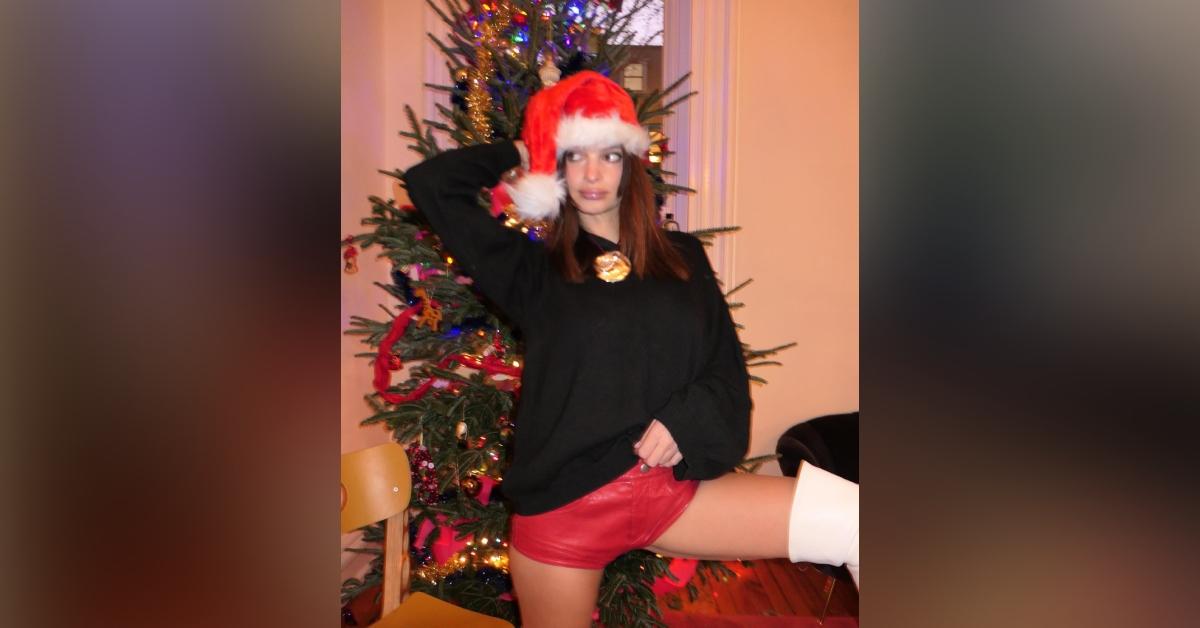 emily ratajkowski shorts boots santa hat decoarting christmas photos